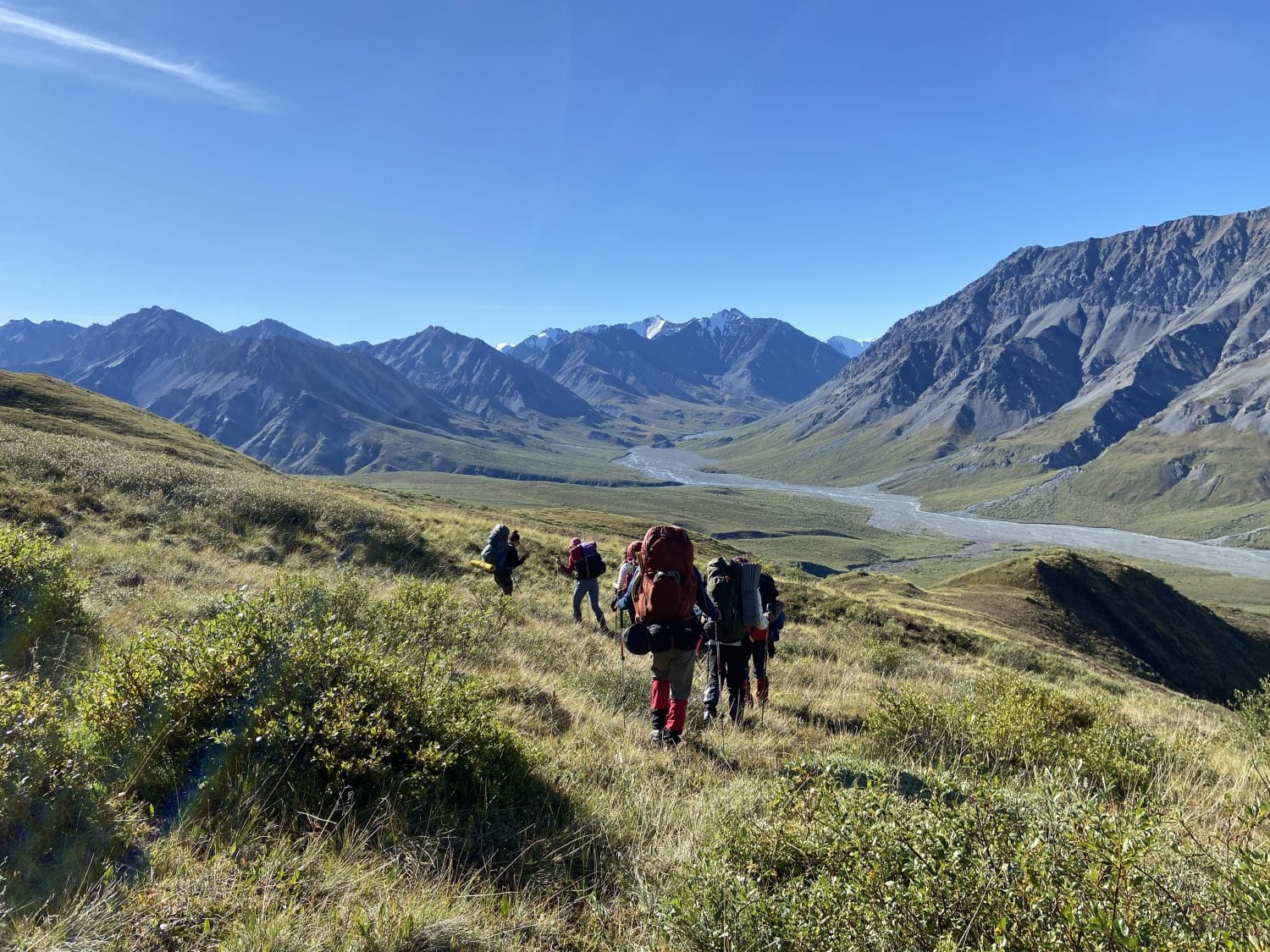 Backpackers hiking in a river valley Kluane National Park