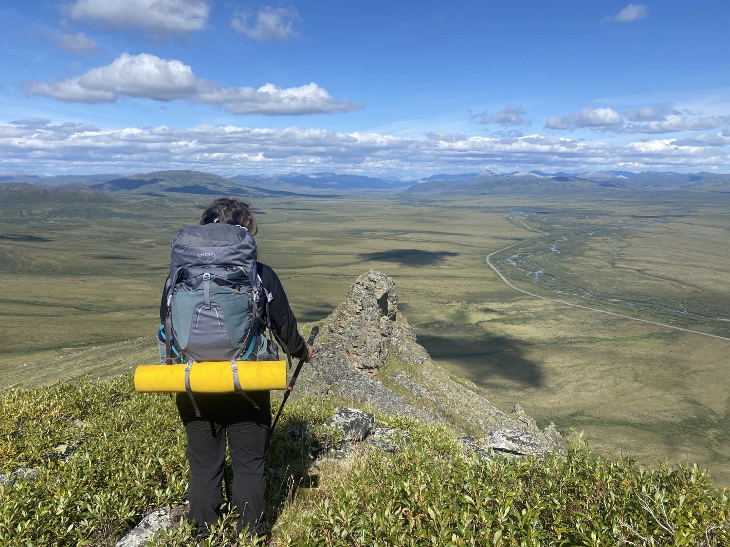 Hiker overlooking the Dempster Highway in Tombstone territorial park