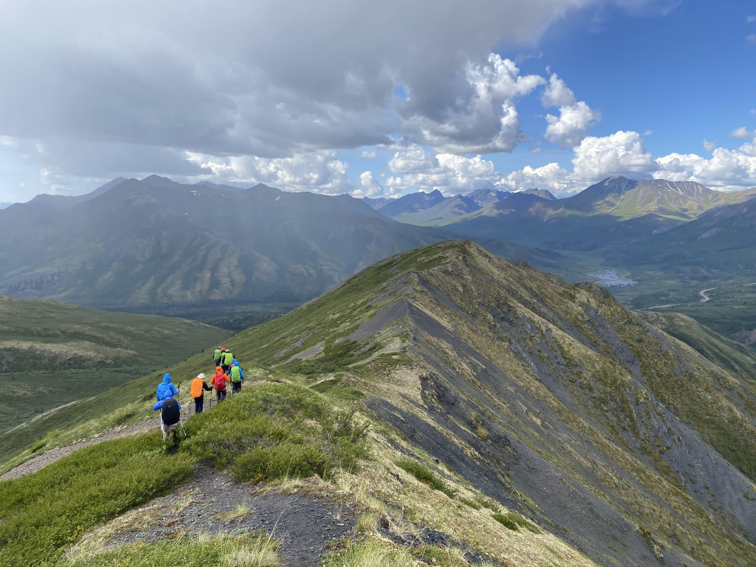 Hikers on a mountain ridge trail