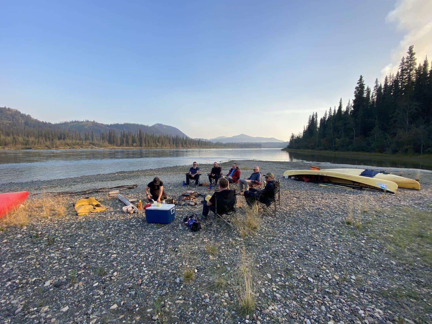 Group gathering by the riverbank.