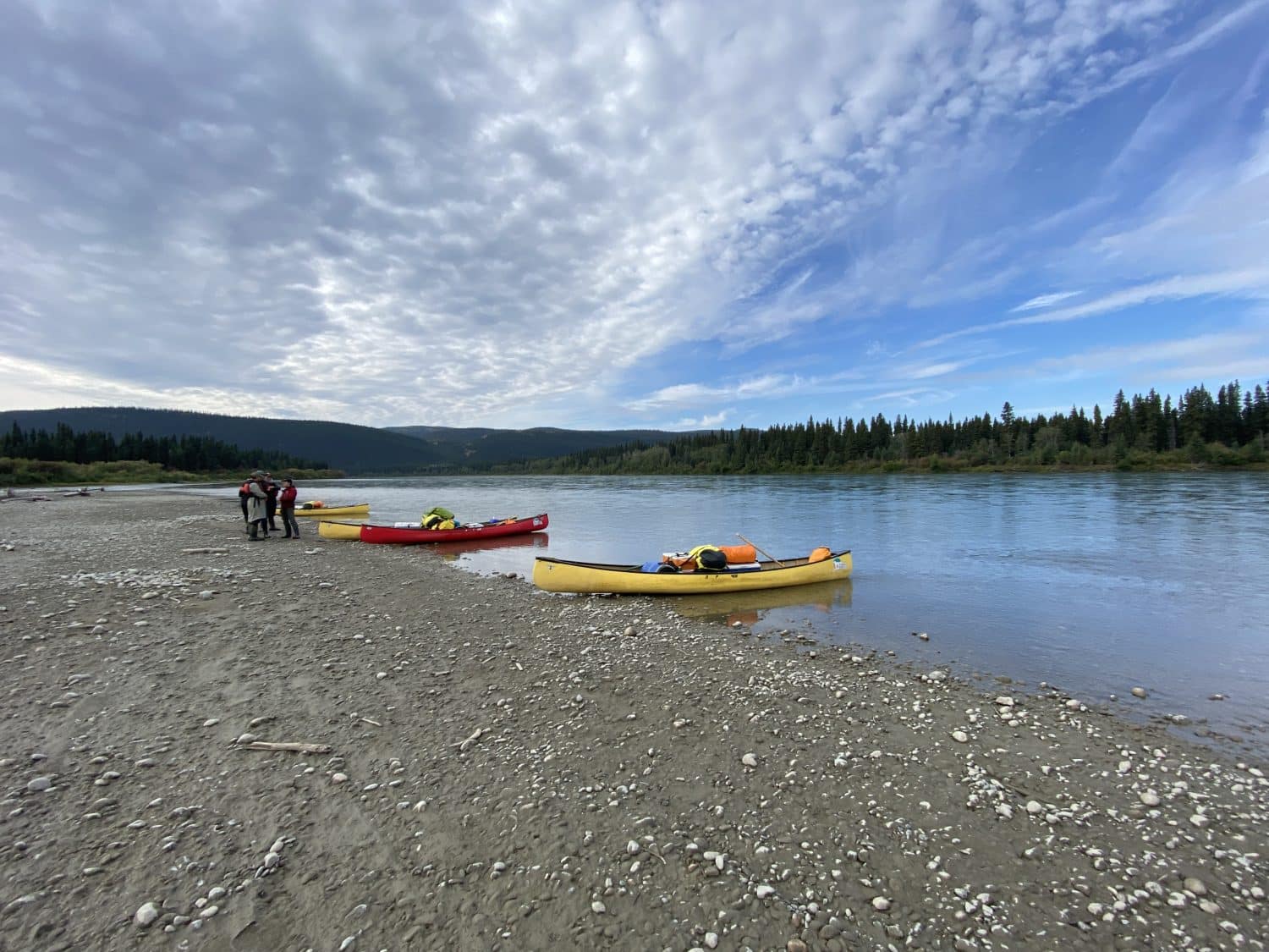 Kayaks on a sandy riverbank